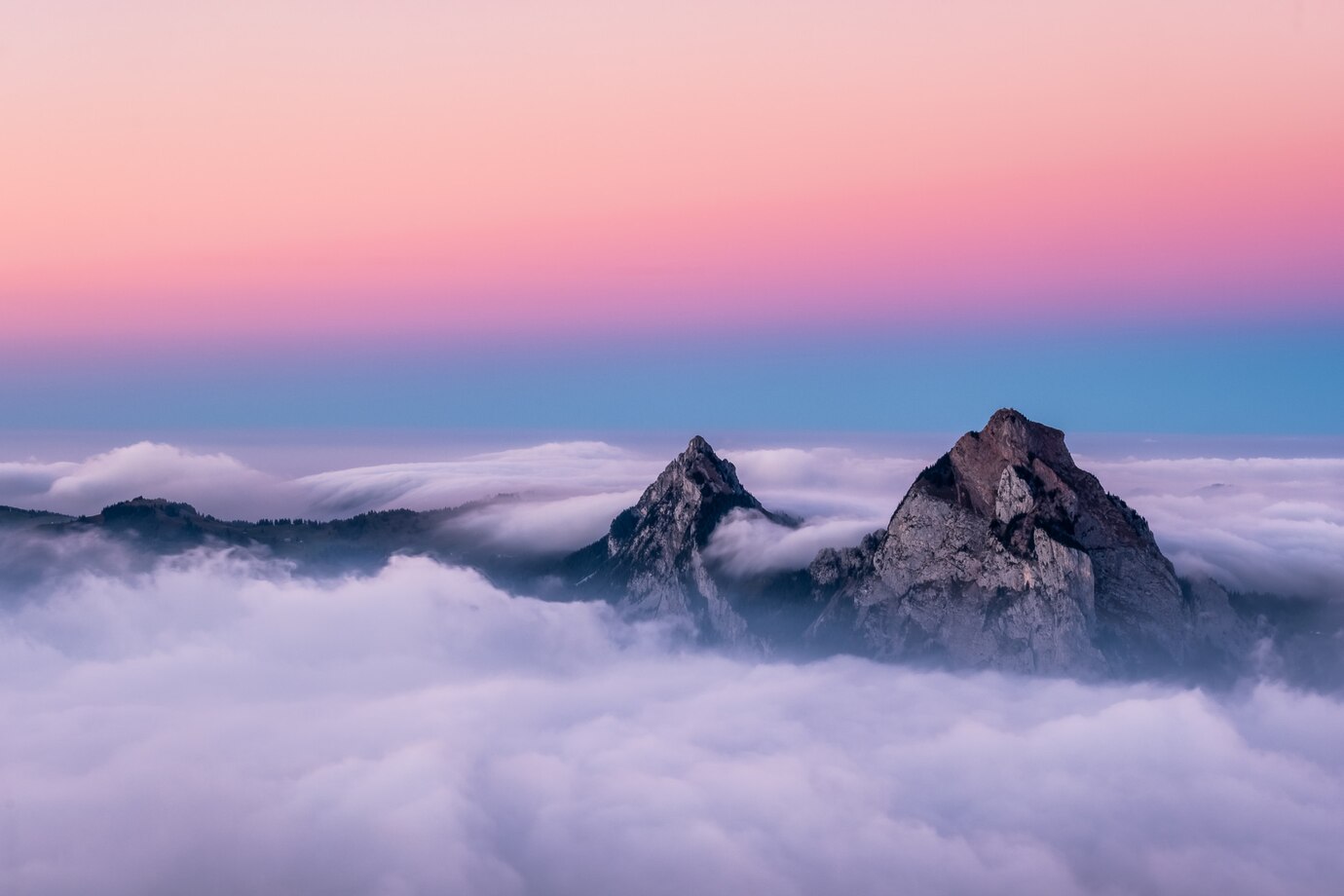 beautiful-aerial-shot-fronalpstock-mountains-switzerland-beautiful-pink-blue-sky_181624-9315